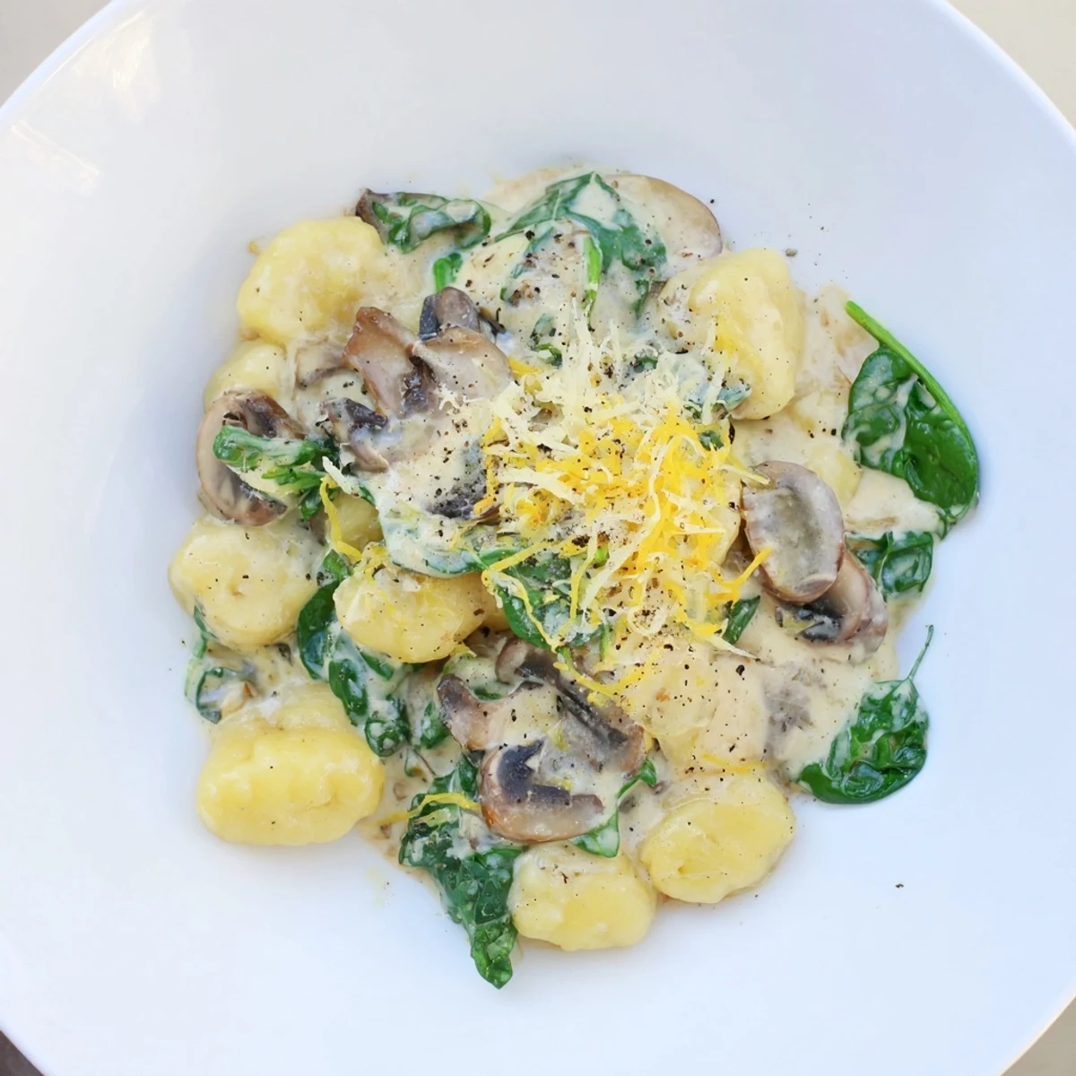 Fresh, flavorful One-Dish Creamy Mushroom and Spinach Gnocchi featuring vibrant spinach and tender mushrooms.