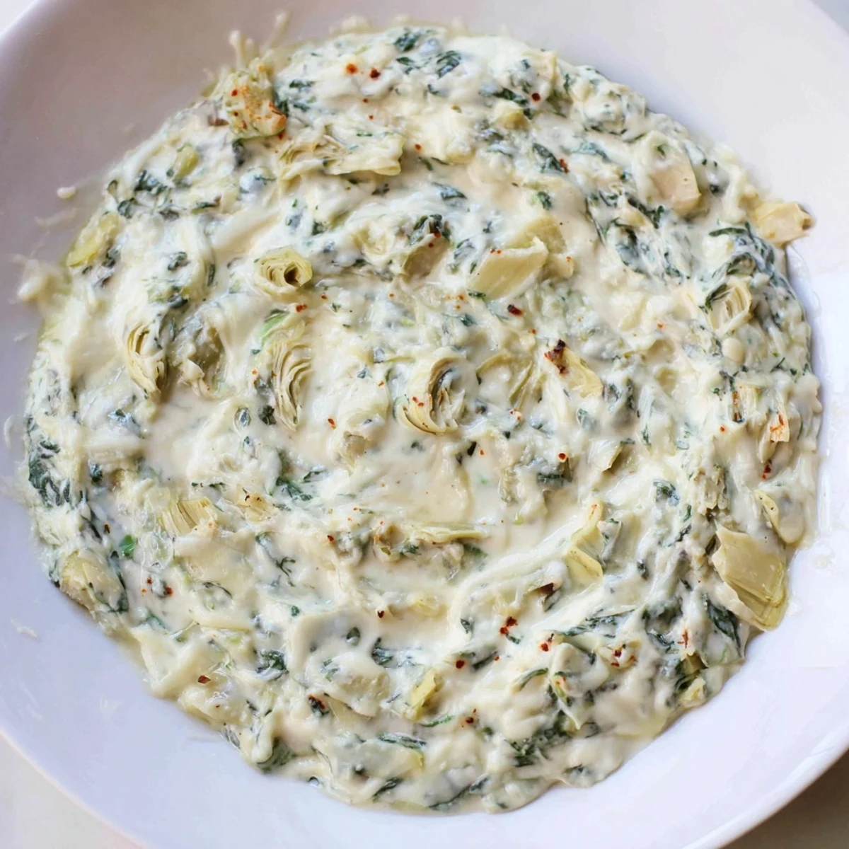 Warm Spinach Artichoke Dip, a creamy appetizer, loaded with cheesy goodness, perfect for snacking.