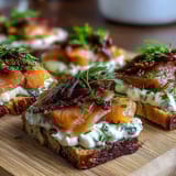Cucumber Bites with Cream Cheese and Smoked Salmon arranged on a platter with fresh dill and capers.