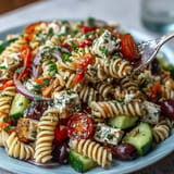 Creamy, refreshing Memorial Day Pasta Salad with Italian Dressing and Veggies, featuring crisp cucumbers, cherry tomatoes, and olives.  