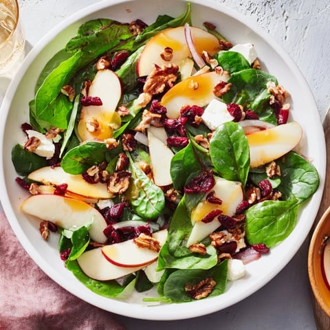 Bright Christmas salad: Vibrant Seasonal Cranberry and Walnut Celebration Salad with a zesty orange vinaigrette.