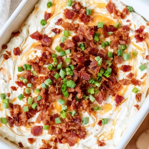 Warm, creamy Cheesy Bacon Ranch Dip: a baked appetizer with melted cheddar and ranch flavor.