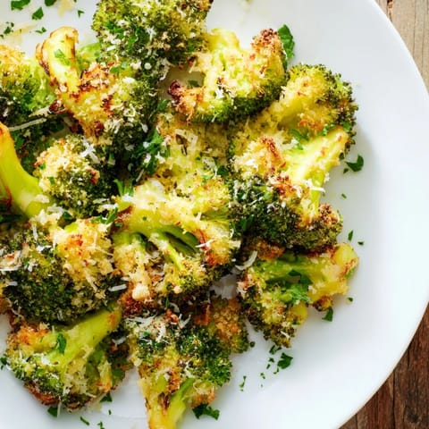 A close-up of perfectly roasted Garlic Parmesan Roasted Broccoli, showcasing cheesy, savory goodness.