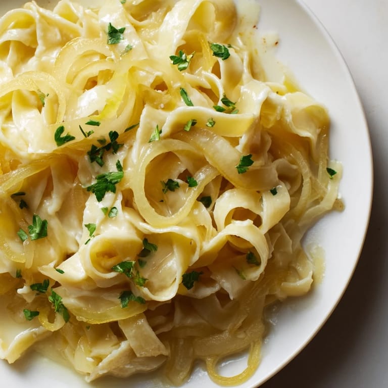 A steaming bowl of One-Pot French Onion Pasta, featuring caramelized onions and bubbling cheese, ready to enjoy.