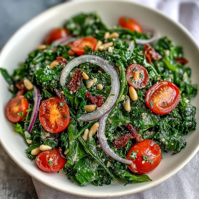 Zesty dandelion greens tossed in lemon vinaigrette, topped with Parmesan, cherry tomatoes, and pine nuts for a vibrant vegetarian salad.