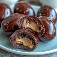 Homemade peanut butter Easter eggs with a creamy center and glossy chocolate coating, perfect for festive holiday treats.  