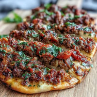 Turkish Lahmacun featuring crispy crust, savory lamb, and vibrant sumac.